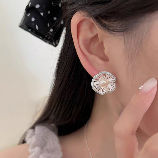 Blue enamel fan earrings worn on model, pearl accent detail