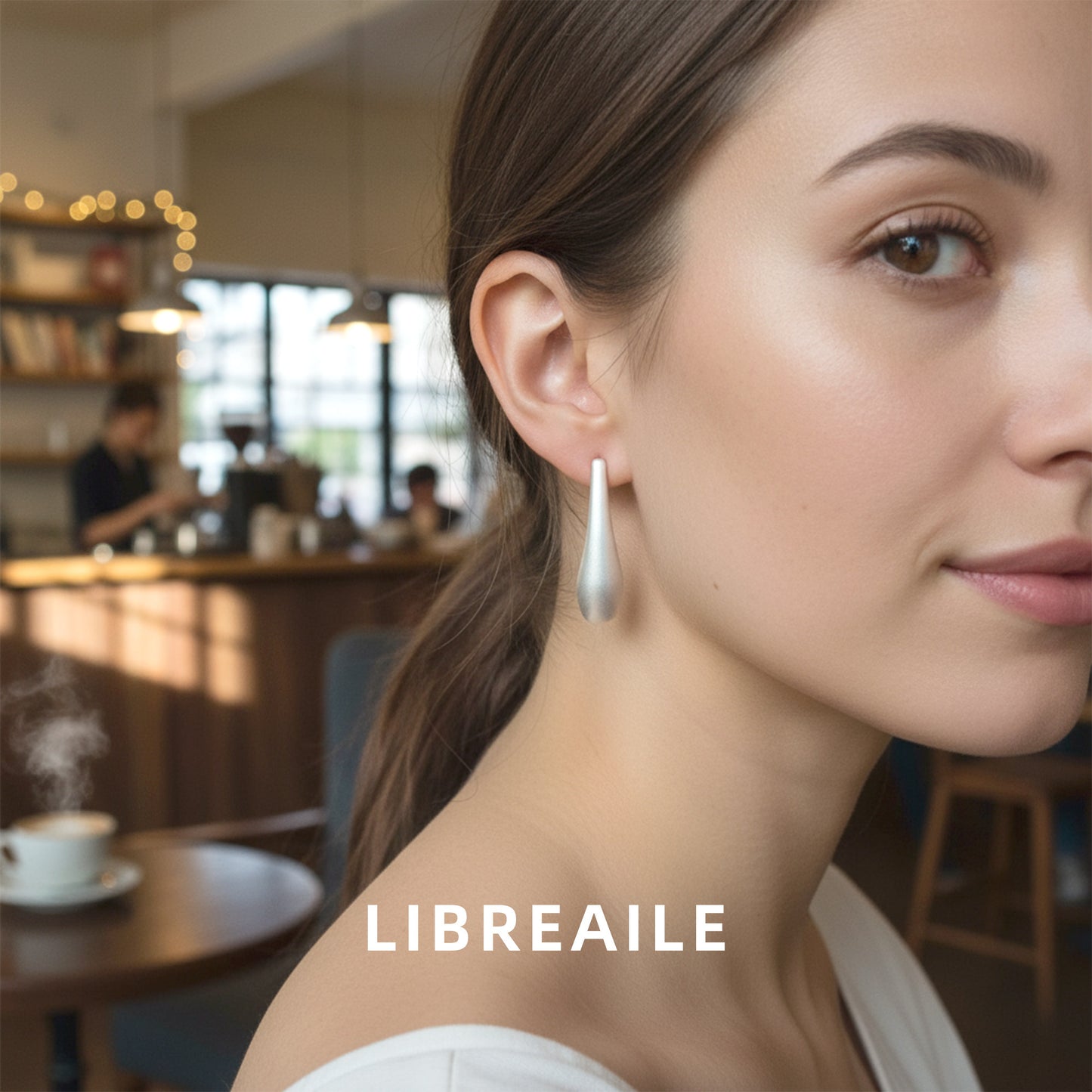 Dainty silver raindrop earrings side angle, minimalist design