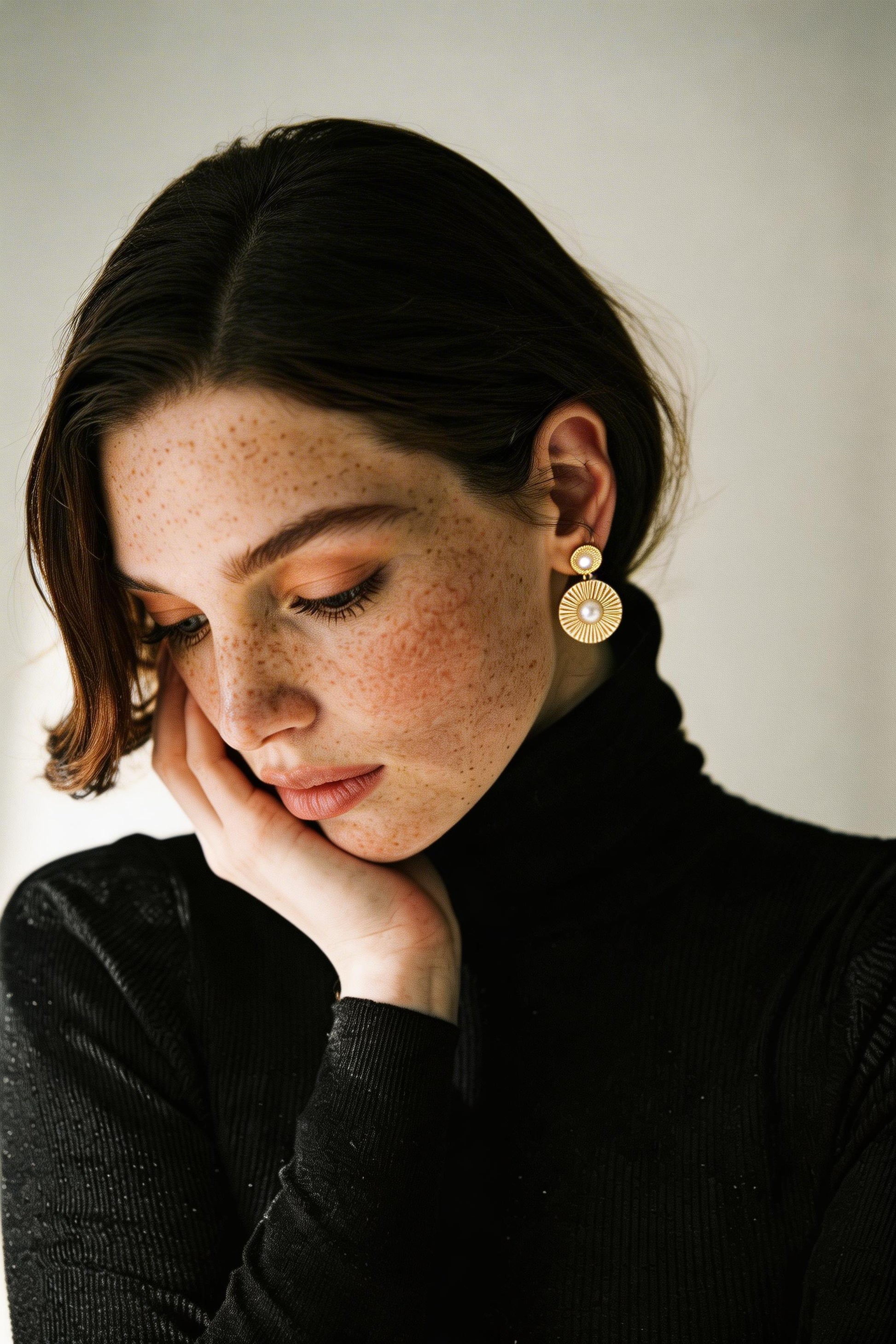 Vintage disc earrings with natural pearl accent, side angle