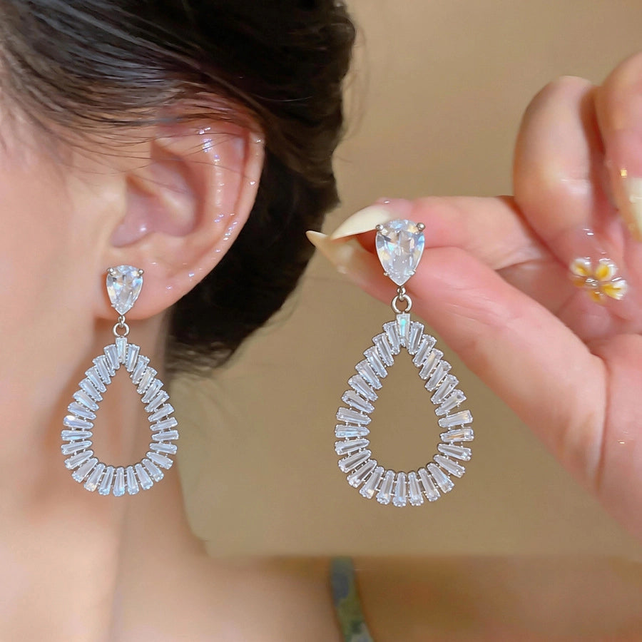 The Liquid Contour: Openwork Teardrop Zirconia Studs, close-up detail