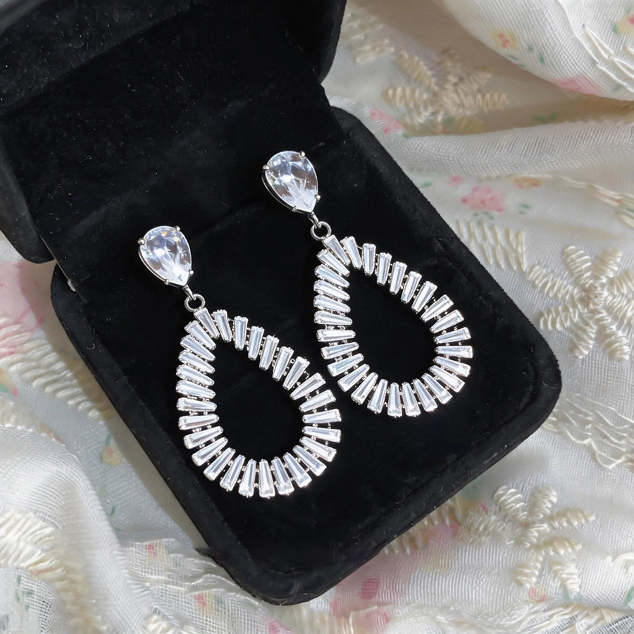 The Liquid Contour: Openwork Teardrop Zirconia Studs, worn on model