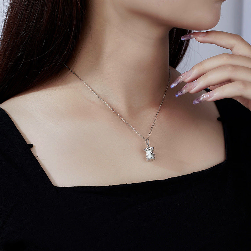 Whimsical carousel necklace flat lay, sterling silver women's jewelry