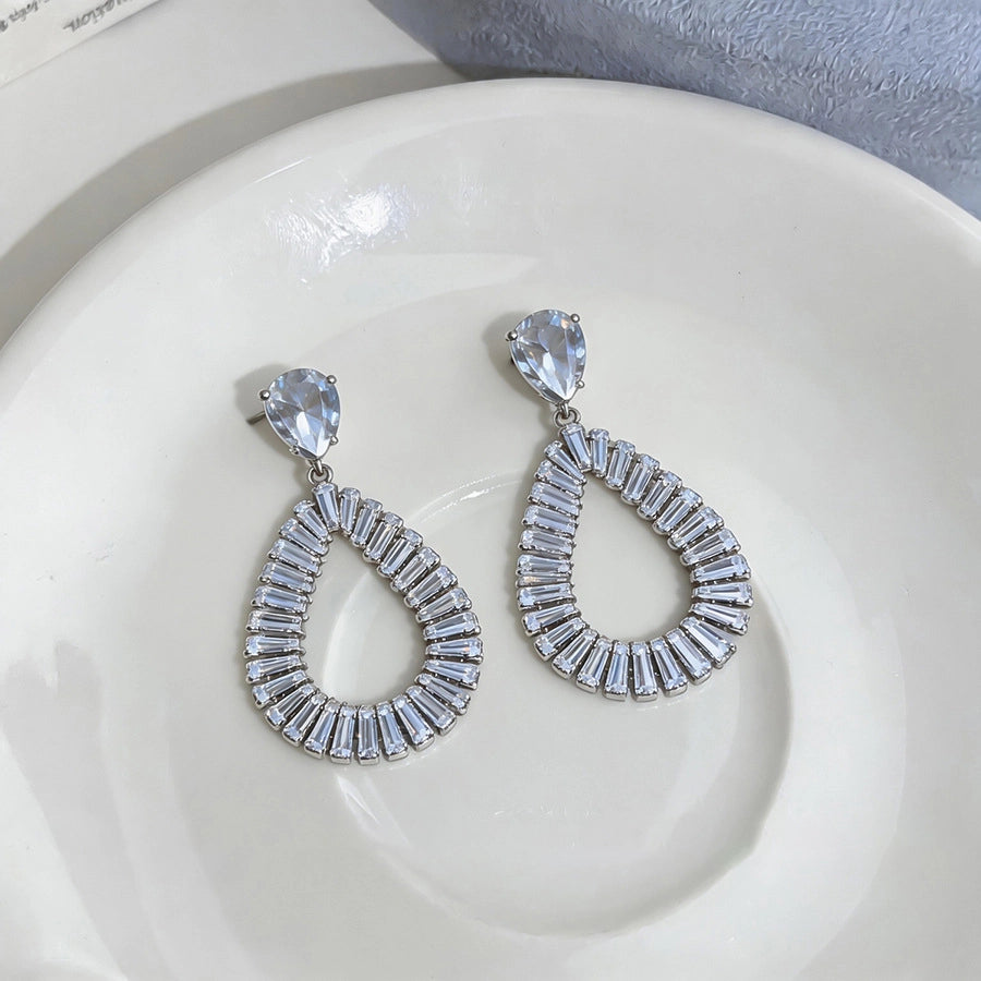 The Liquid Contour: Openwork Teardrop Zirconia Studs, flat lay
